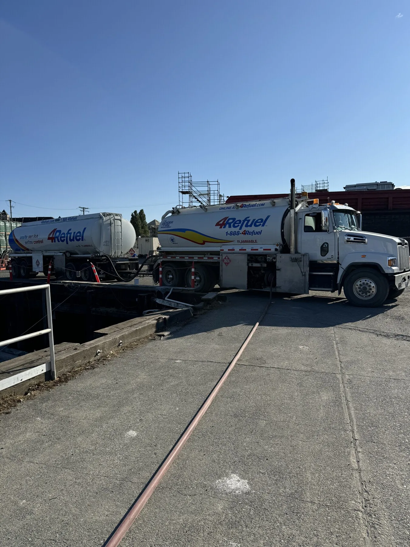 A 4Refuel truck and B-train tanker configuration at a dock